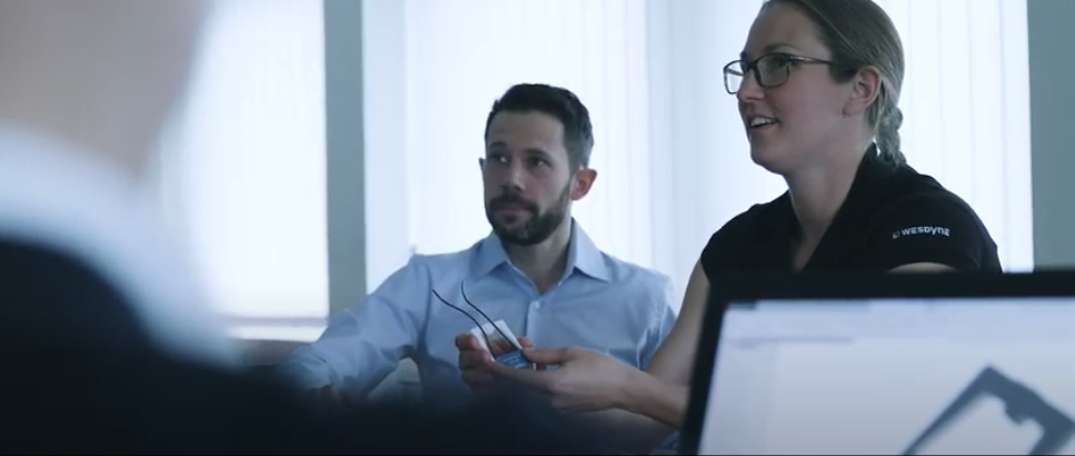 WesDyne man and woman in a meeting