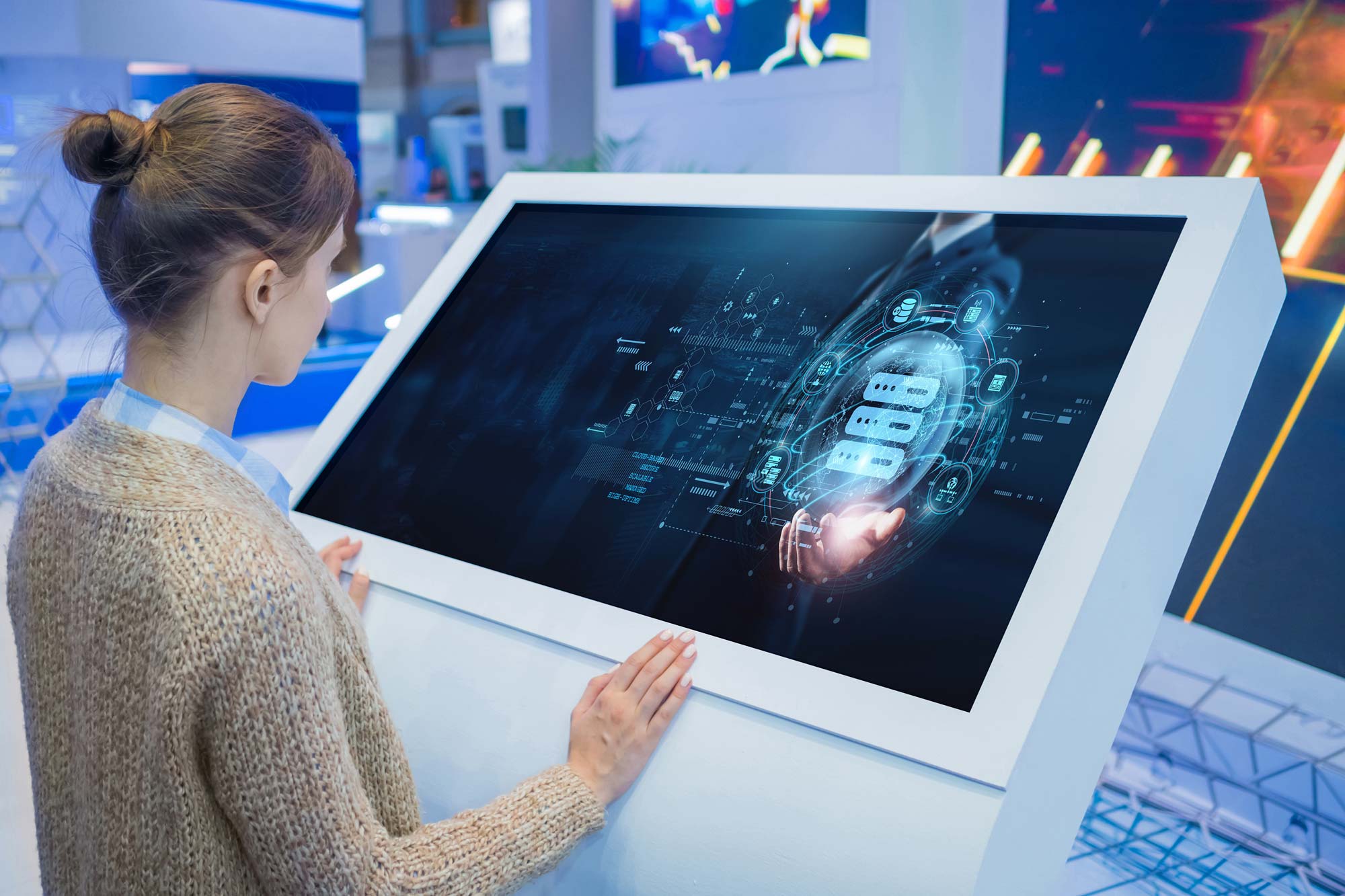 Woman standing in front of a touch screen