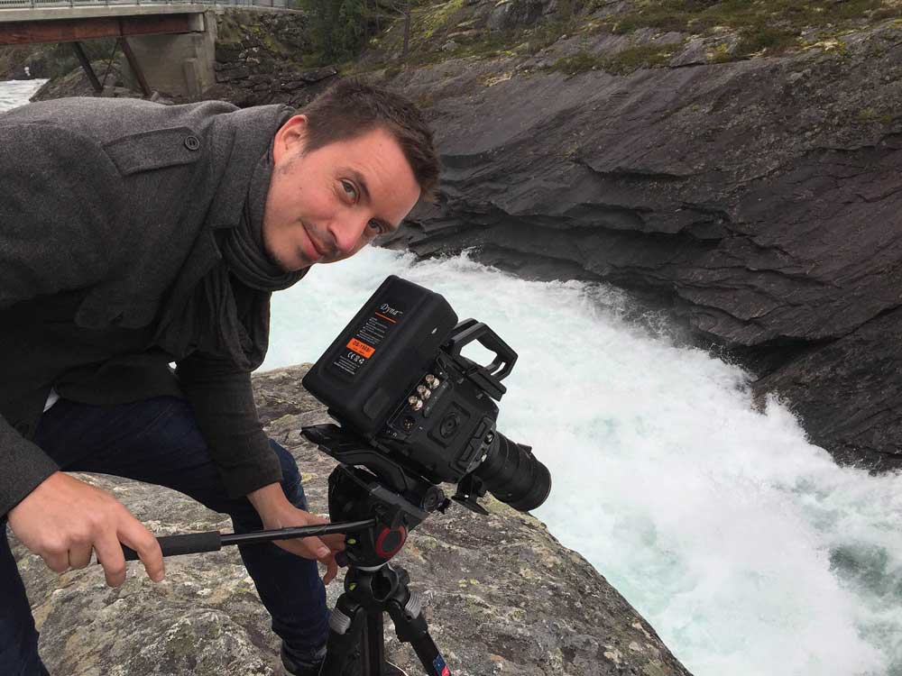 A man films a river